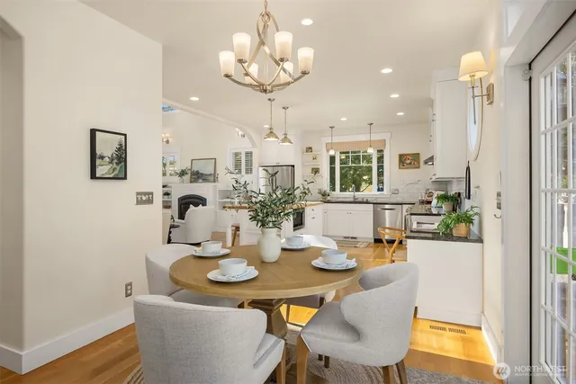 a view of a dining room with furniture and chandelier