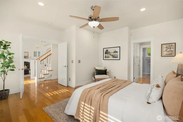 a bedroom with a large bed and a chandelier