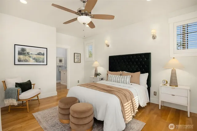 a bedroom with a bed and wooden floor