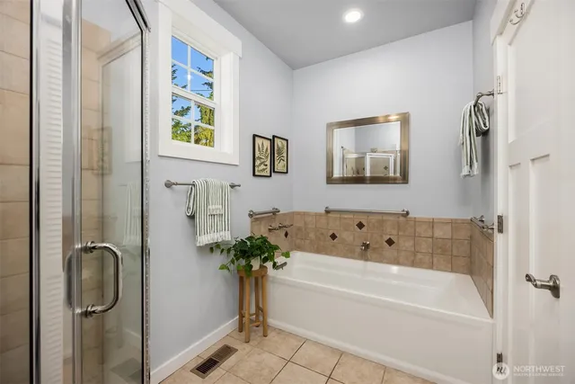 a bathroom with a tub and shower