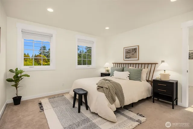 a bedroom with a bed and a potted plant