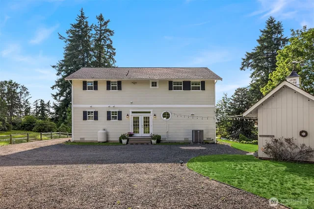 a view of a white house with a yard