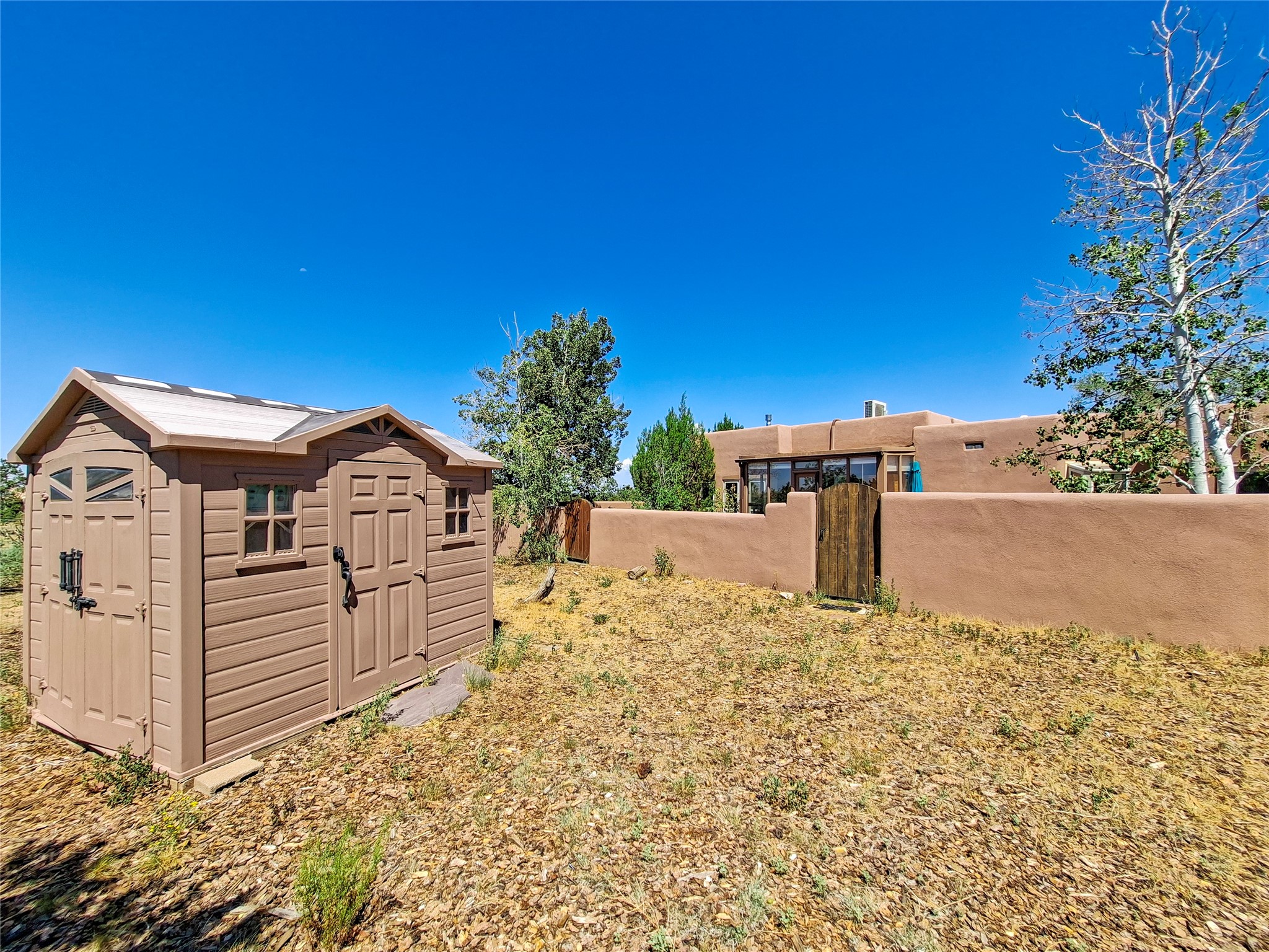 57 Verano Loop Santa Fe, NM 87508 - Photo 38 of 43 The shed is outside the enclosed patio