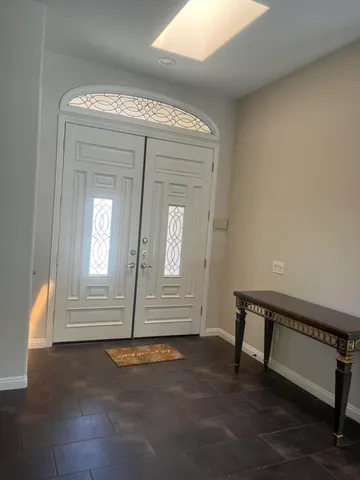 an empty room with windows and fireplace