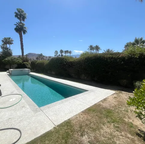 a view of a swimming pool with a yard