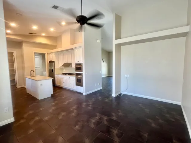 a view of a kitchen with a sink and cabinets