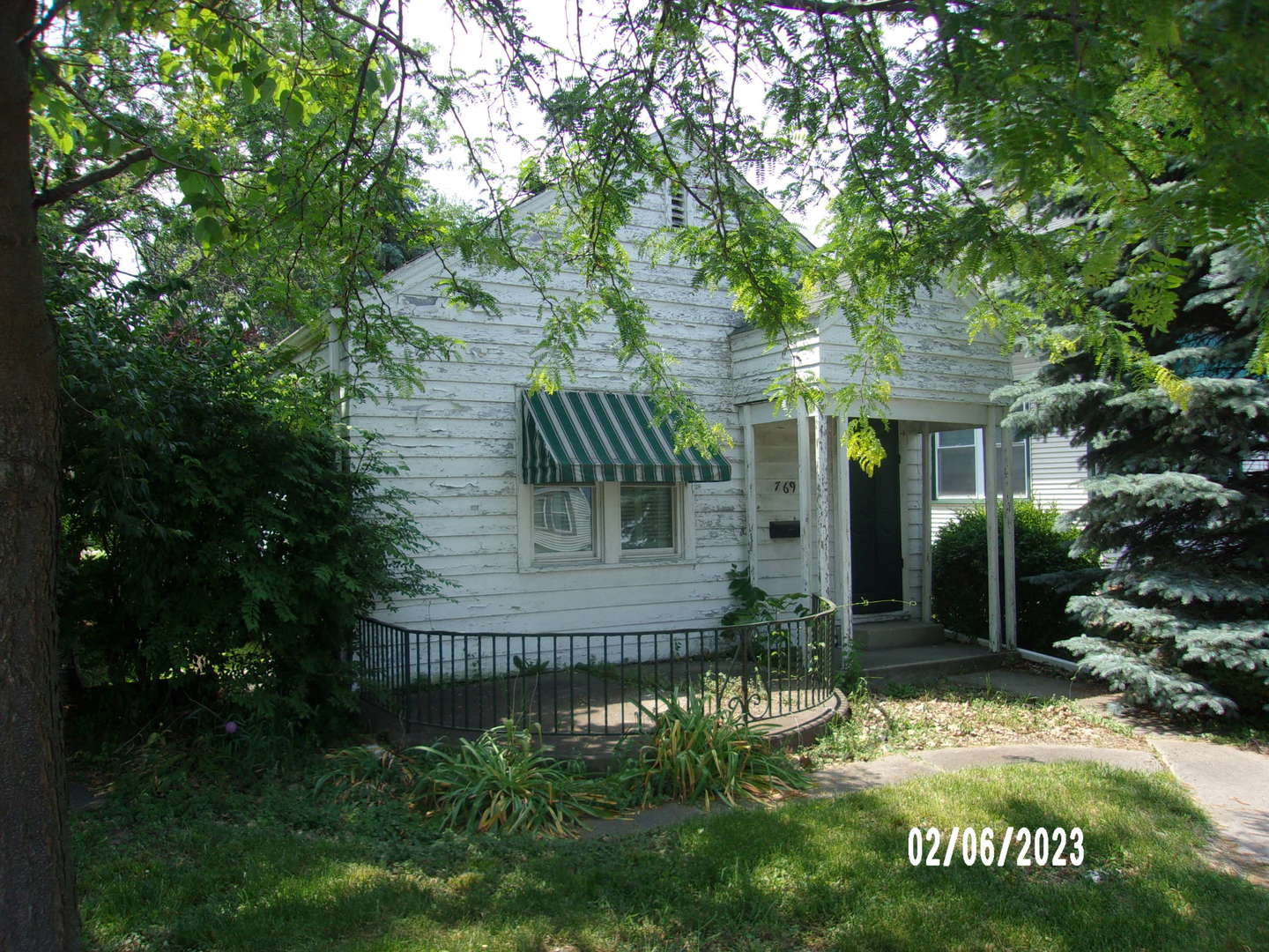 769 Kennedy Drive Kankakee, IL 60901 - Photo 1 of 15 a view of a house with a small yard plants and large tree