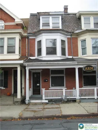 a view of a brick building with many windows
