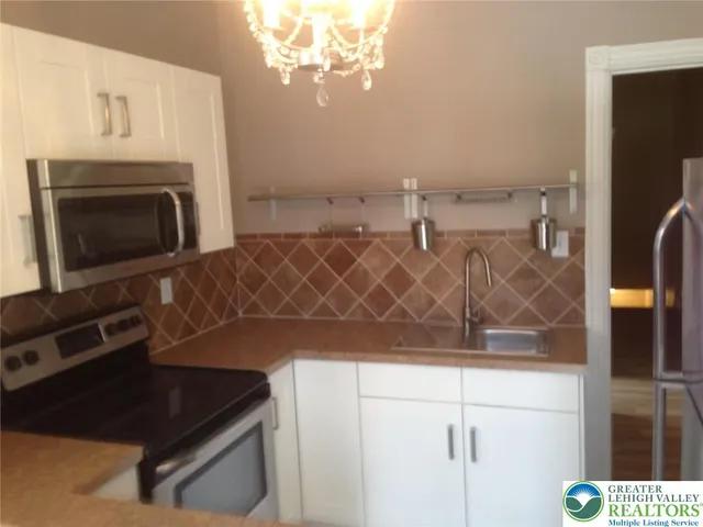 a kitchen with cabinets and a stove top oven