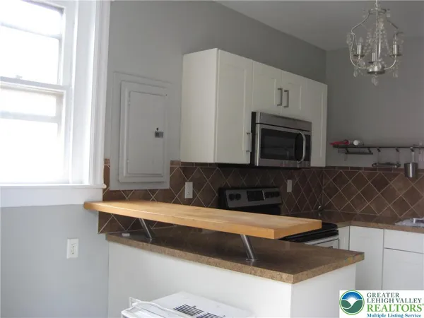 a kitchen with a sink and a microwave