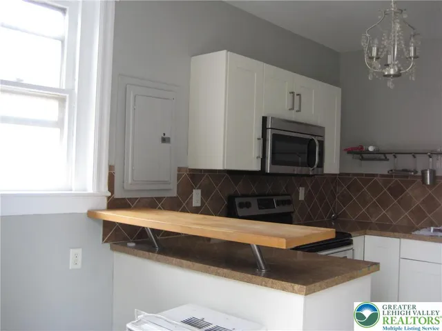a kitchen with a sink and a microwave