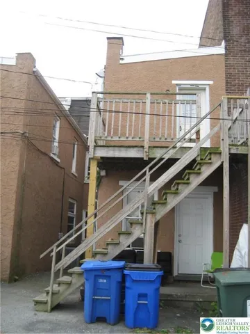 a view of a balcony with wooden floor and fence