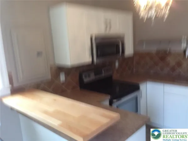 a kitchen with a sink and a refrigerator