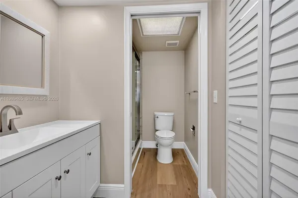 a bathroom with a toilet sink and a mirror