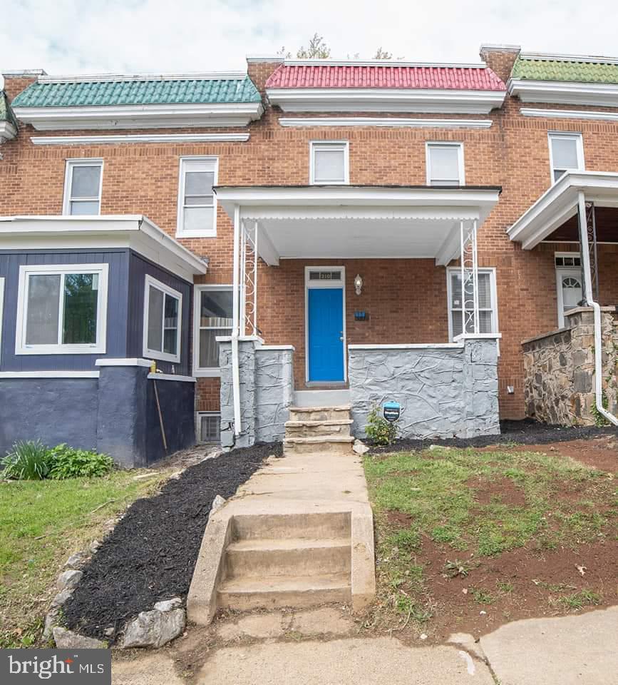 310 Marydell Road Baltimore, MD 21229 - Photo 1 of 26 a front view of a house with a garden