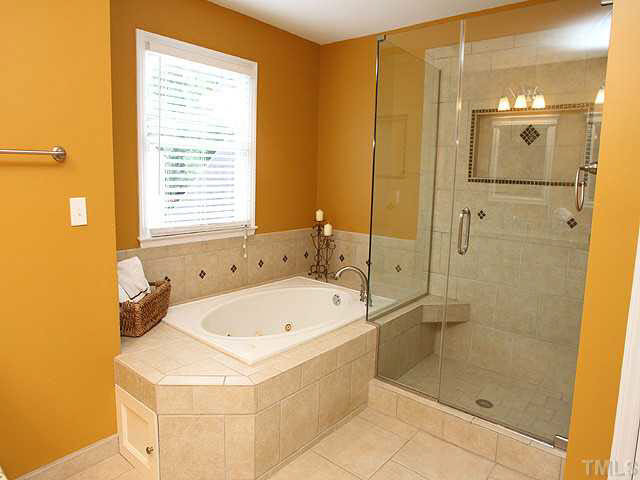 8405 Evans Mill Place Raleigh, NC 27613 - Photo 15 of 25 The master bath has been remodeled with a large walk in shower with niche, garden tub and separate commode room. Master Bath/Spa