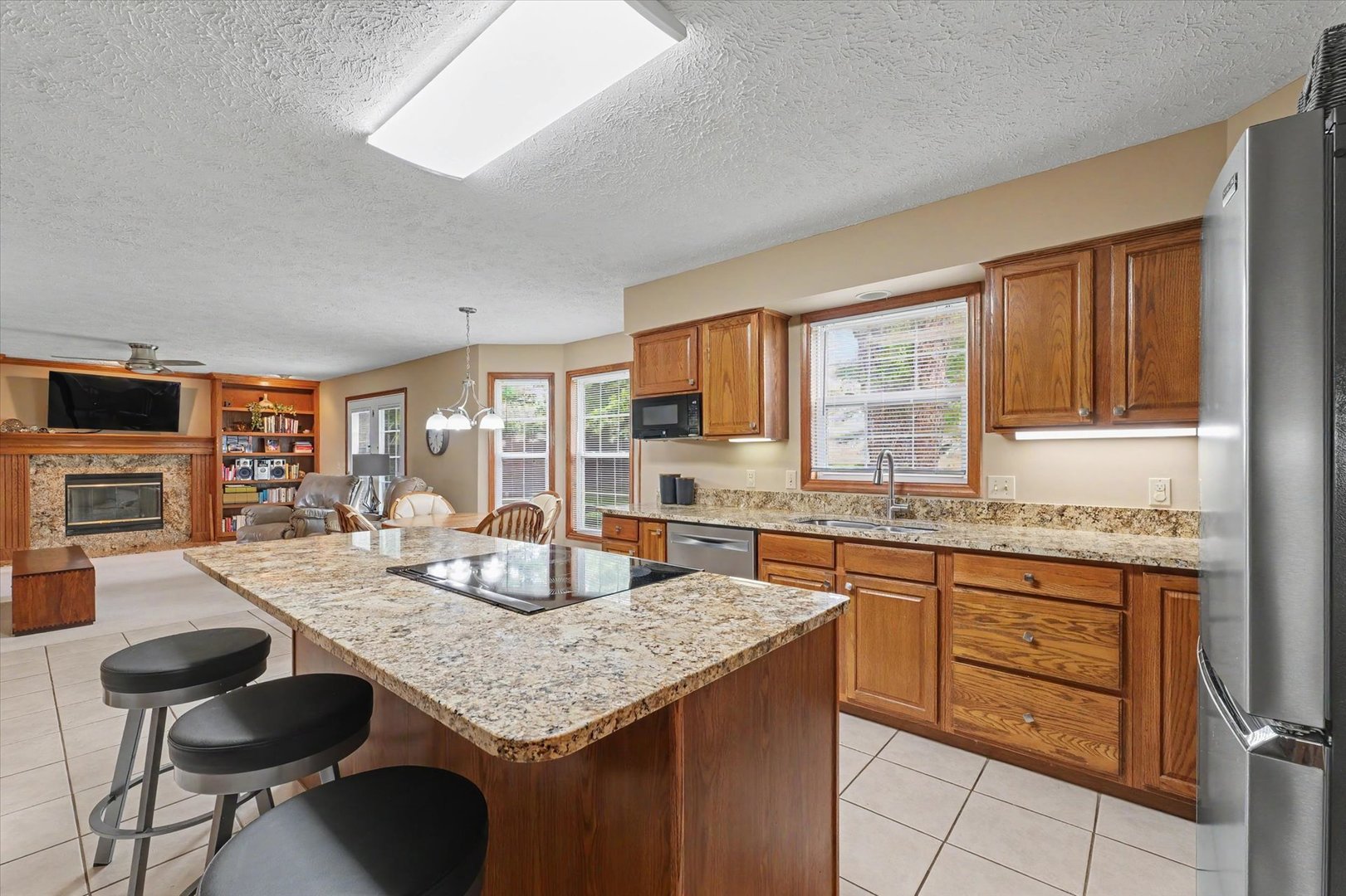 4409 Copper Ridge Road Champaign, IL 61822 - Photo 17 of 40 a kitchen with granite countertop sink stove and dining table