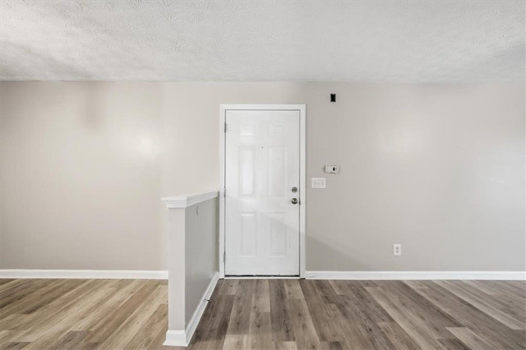 8201 Fairington Ridge Circle Lithonia, GA 30038 - Photo 2 of 9 a view of an empty room with wooden floor
