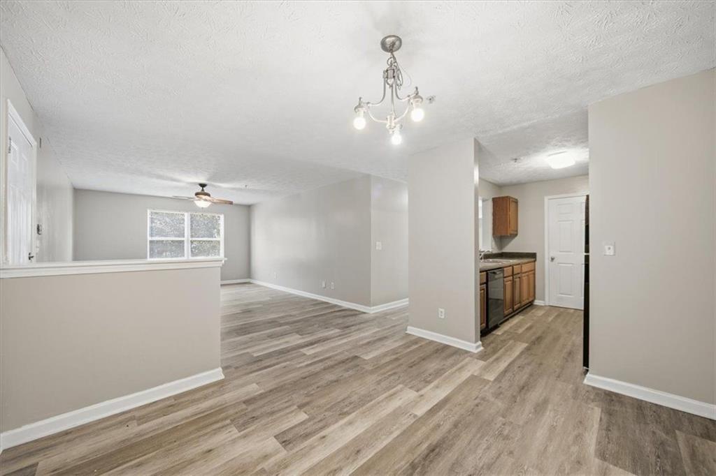 8201 Fairington Ridge Circle Lithonia, GA 30038 - Photo 5 of 9 a view of a big room with wooden floor and kitchen