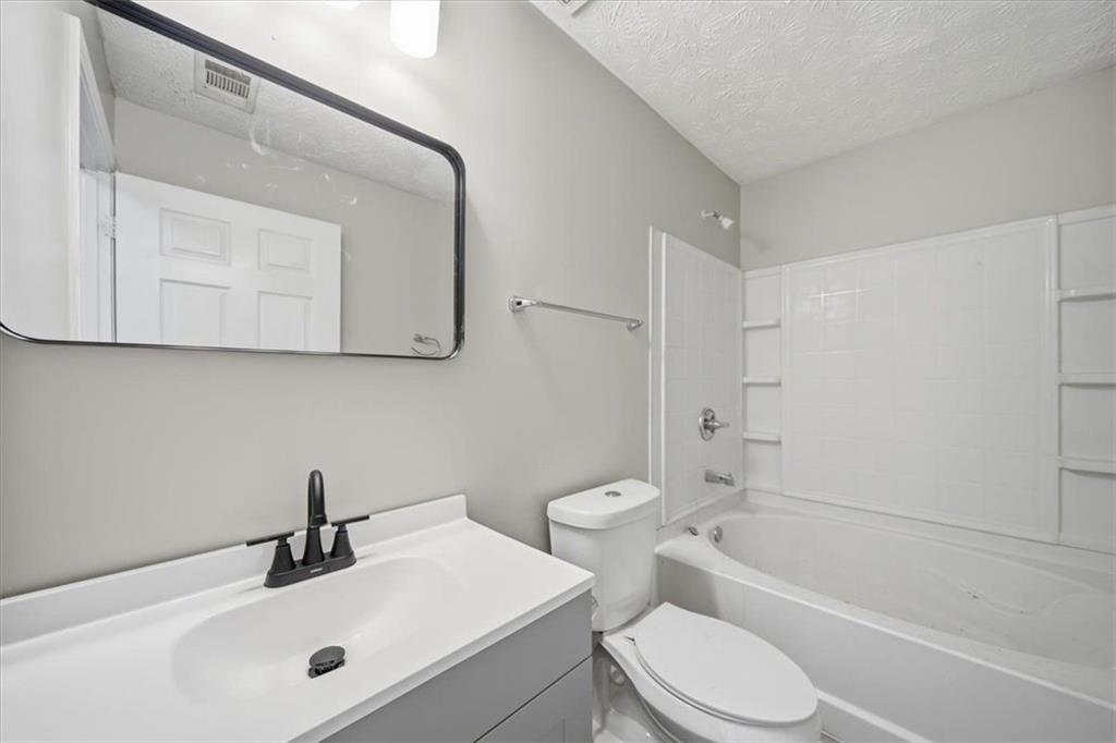 8201 Fairington Ridge Circle Lithonia, GA 30038 - Photo 7 of 9 a bathroom with a sink a toilet and bathtub