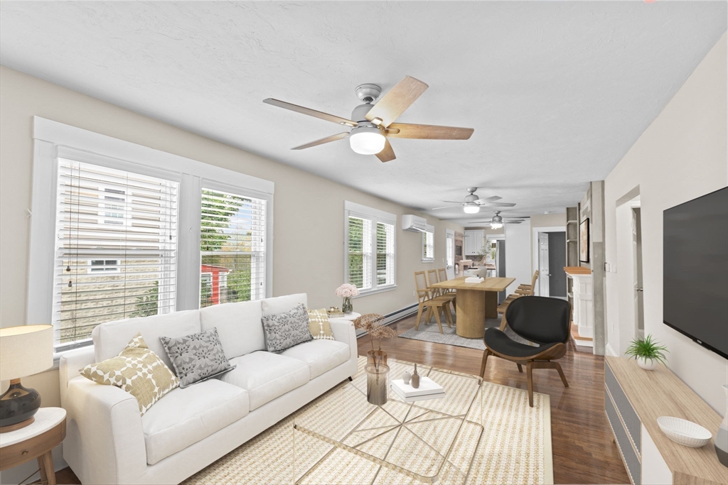 31 Crawford Road Braintree, MA 02184 - Photo 3 of 18 a living room with furniture a flat screen tv and a large window