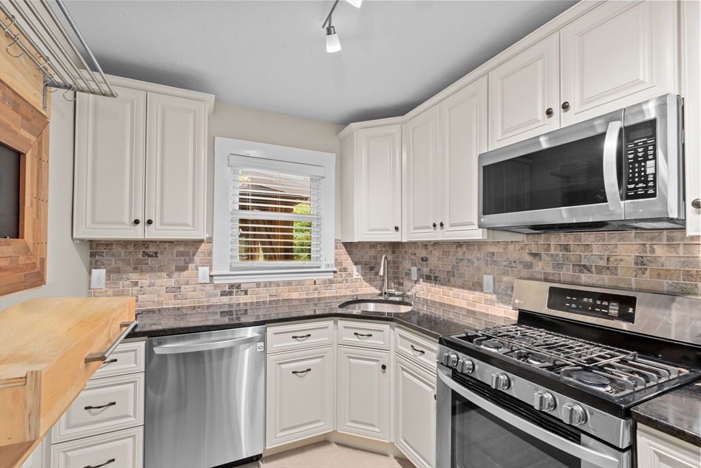 31 Crawford Road Braintree, MA 02184 - Photo 5 of 18 a kitchen with stainless steel appliances granite countertop a stove a sink and a microwave