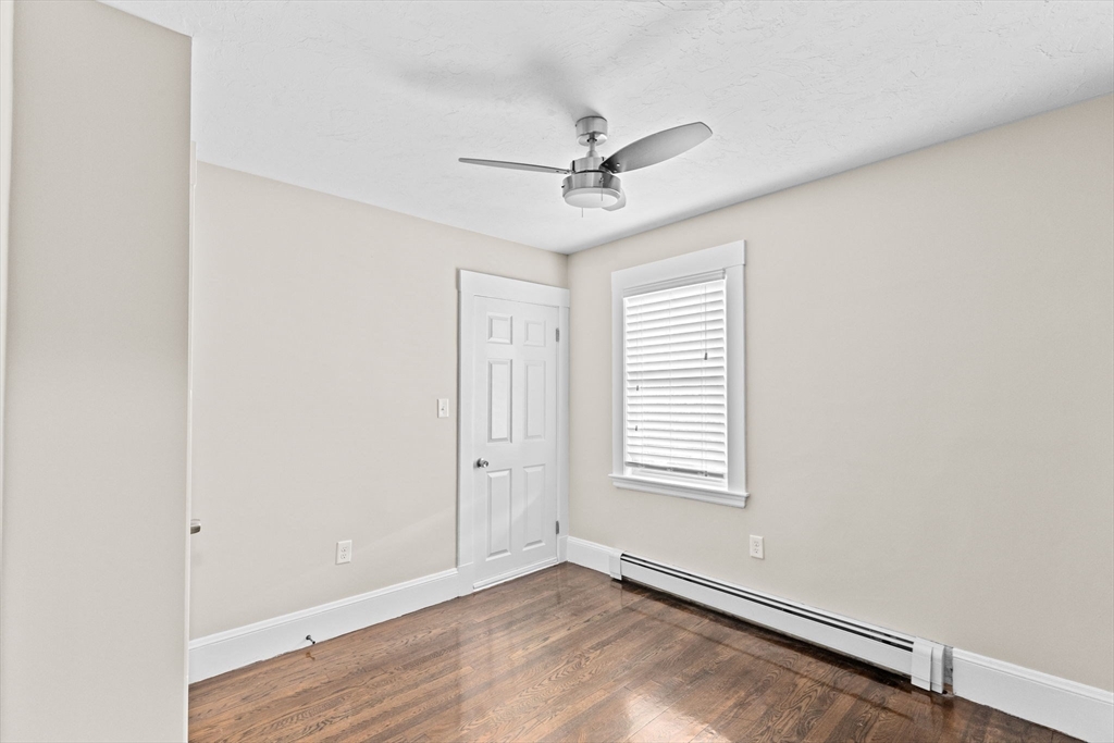 31 Crawford Road Braintree, MA 02184 - Photo 8 of 18 an empty room with windows and fan