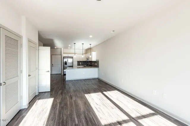 a view of a kitchen with wooden floor and electronic appliances