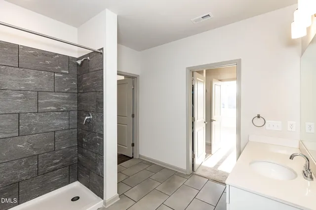a bathroom with a tub a sink and a shower