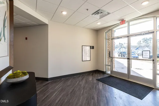 a view of kids room with wooden floor and windows