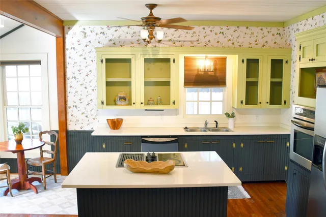 a kitchen with a sink stove and cabinets