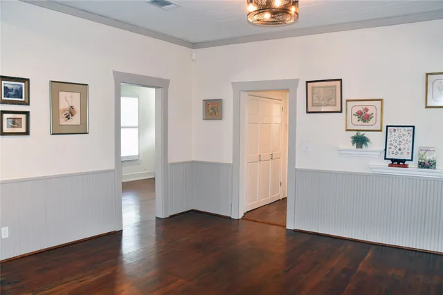 a view of a big room with wooden floor and windows