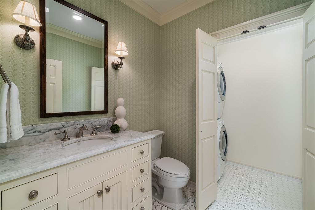 2315 Routh Street Dallas, TX 75201 - Photo 22 of 38 a bathroom with a granite countertop sink toilet and shower