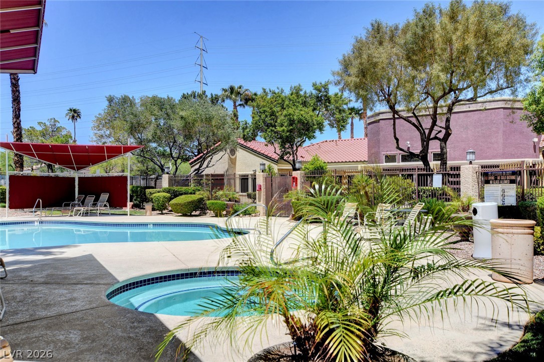 7885 West Flamingo Road, Unit 1050 Las Vegas, NV 89147 - Photo 40 of 62 A refreshing pool and spa area with a shaded lounge space offers community relaxation.