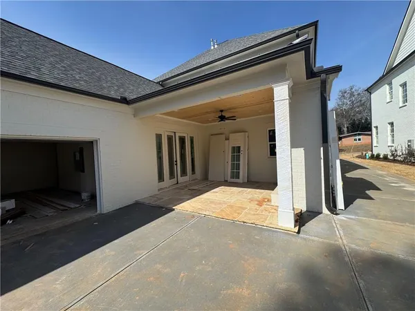a view of a hallway with wooden floor and a door