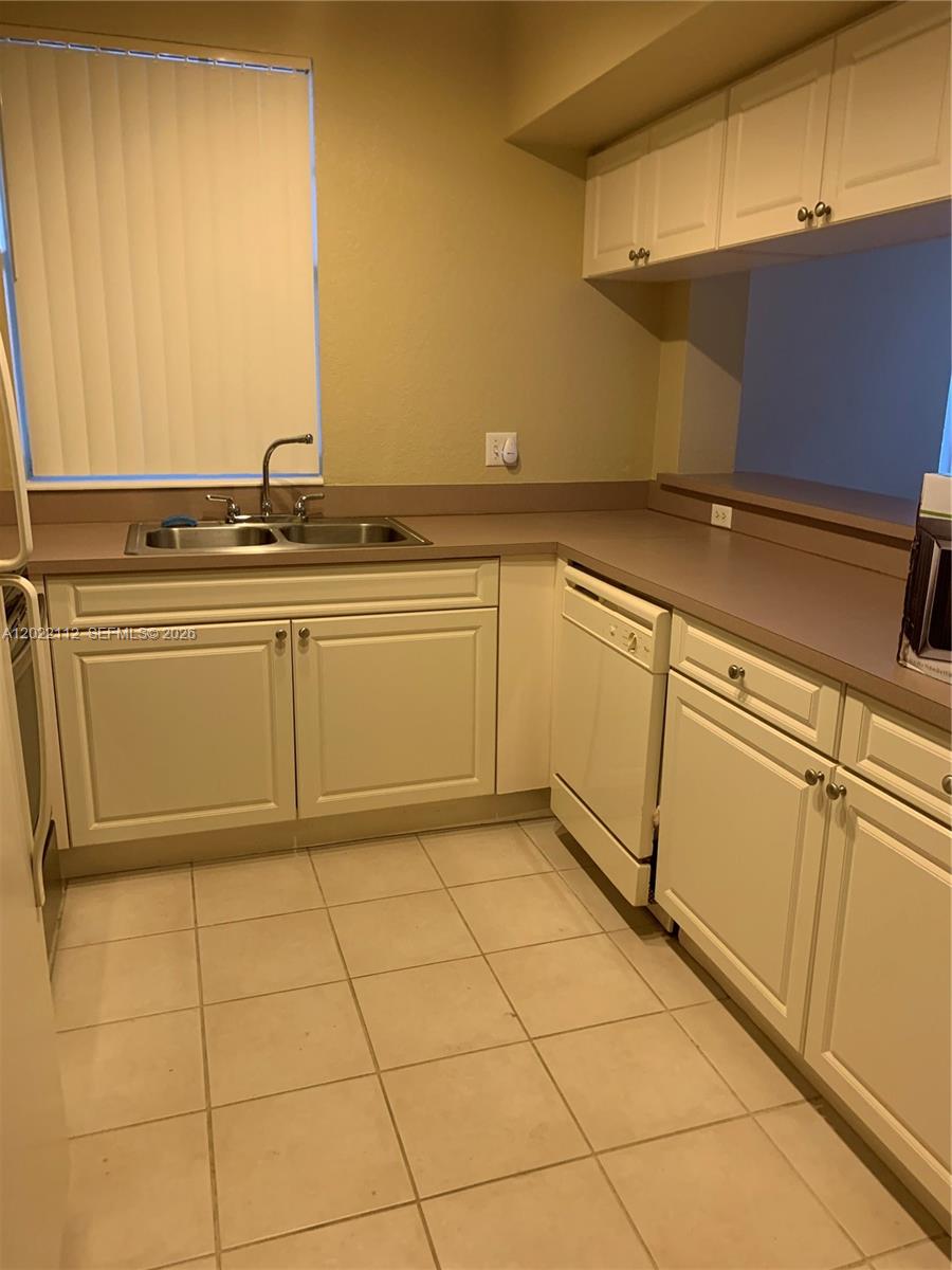 6572 West Sample Road, Unit 6572 Coral Springs, FL 33067 - Photo 2 of 17 a view of a refrigerator and window