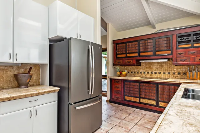 a kitchen with stainless steel appliances granite countertop a refrigerator and a stove