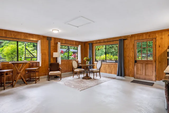 a living room with furniture and large windows