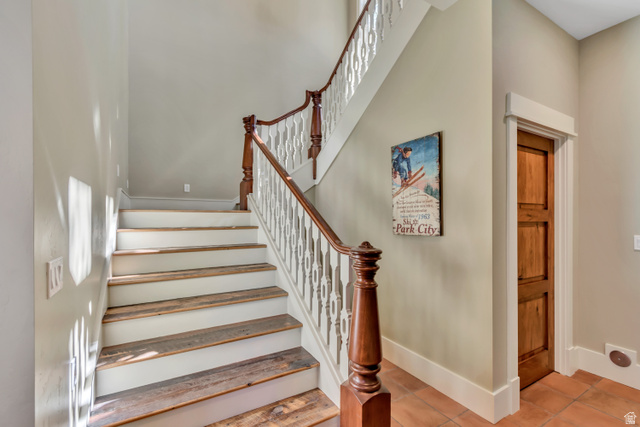 2579 Splendor Valley Road Kamas, UT 84036 - Photo 52 of 87 Stairway featuring tile patterned floors and a high ceiling
