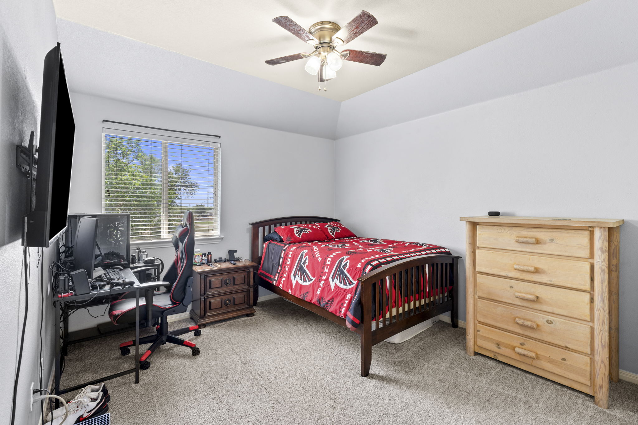227 Sandstone Trail Buda, TX 78610 - Photo 19 of 33 Carpeted room featuring a ceiling fan with integrated lighting, a window with horizontal blinds, and a tray ceiling detail