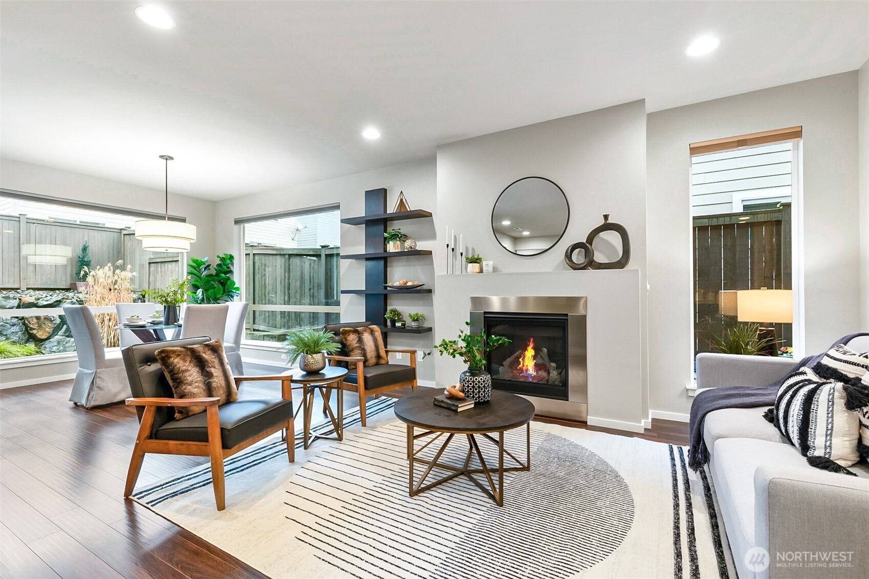 4009 168th Place Southeast Bothell, WA 98012 - Photo 14 of 38 a living room with furniture a fireplace a clock and a large window