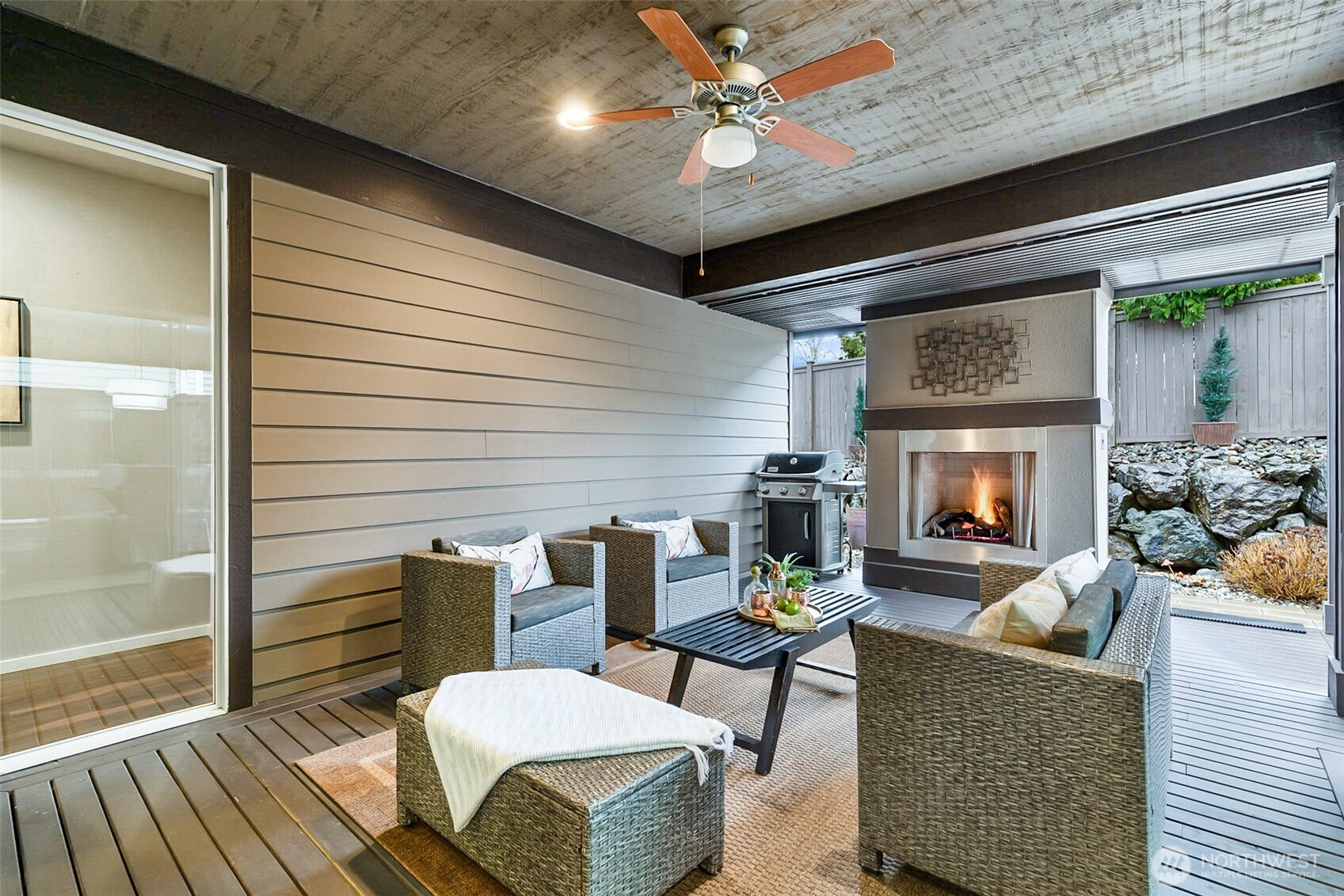 4009 168th Place Southeast Bothell, WA 98012 - Photo 17 of 38 a living room with furniture a fireplace and a ceiling fan