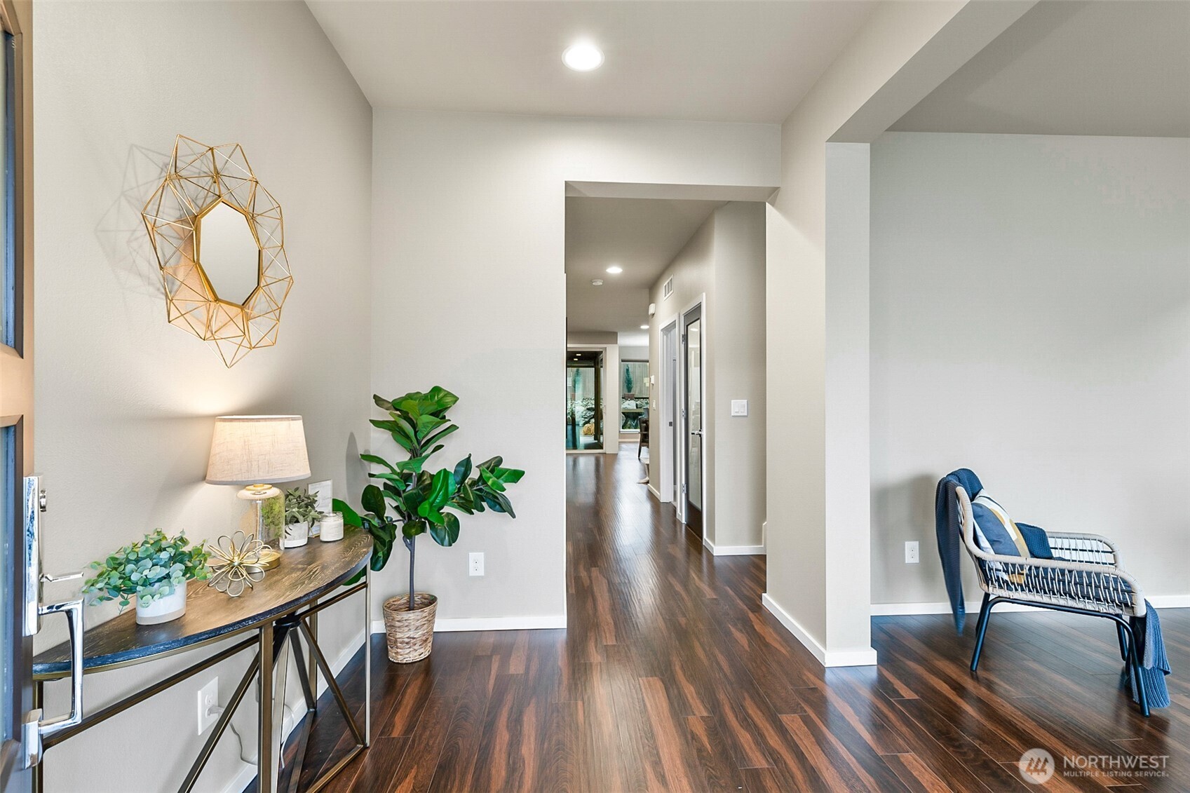 4009 168th Place Southeast Bothell, WA 98012 - Photo 2 of 38 a view of a hallway to dining room with wooden floor table and chairs