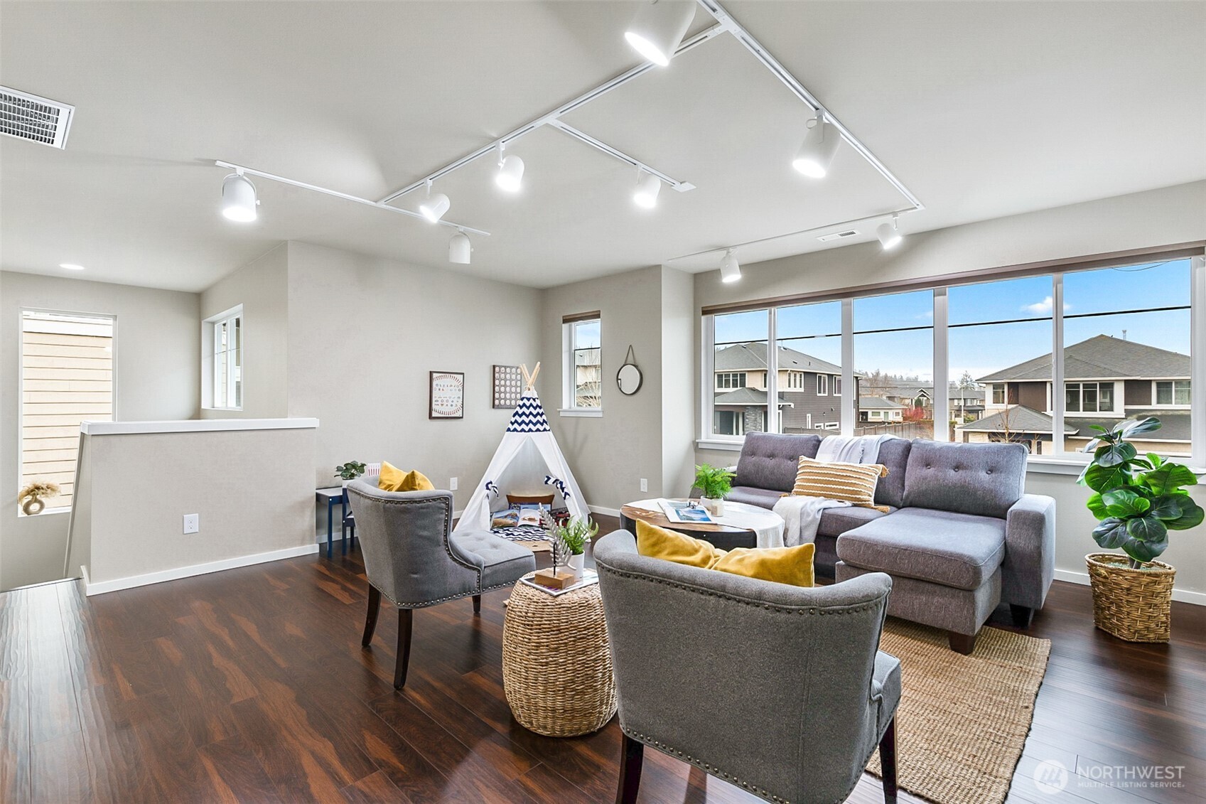 4009 168th Place Southeast Bothell, WA 98012 - Photo 27 of 38 a living room with furniture kitchen view and a wooden floor