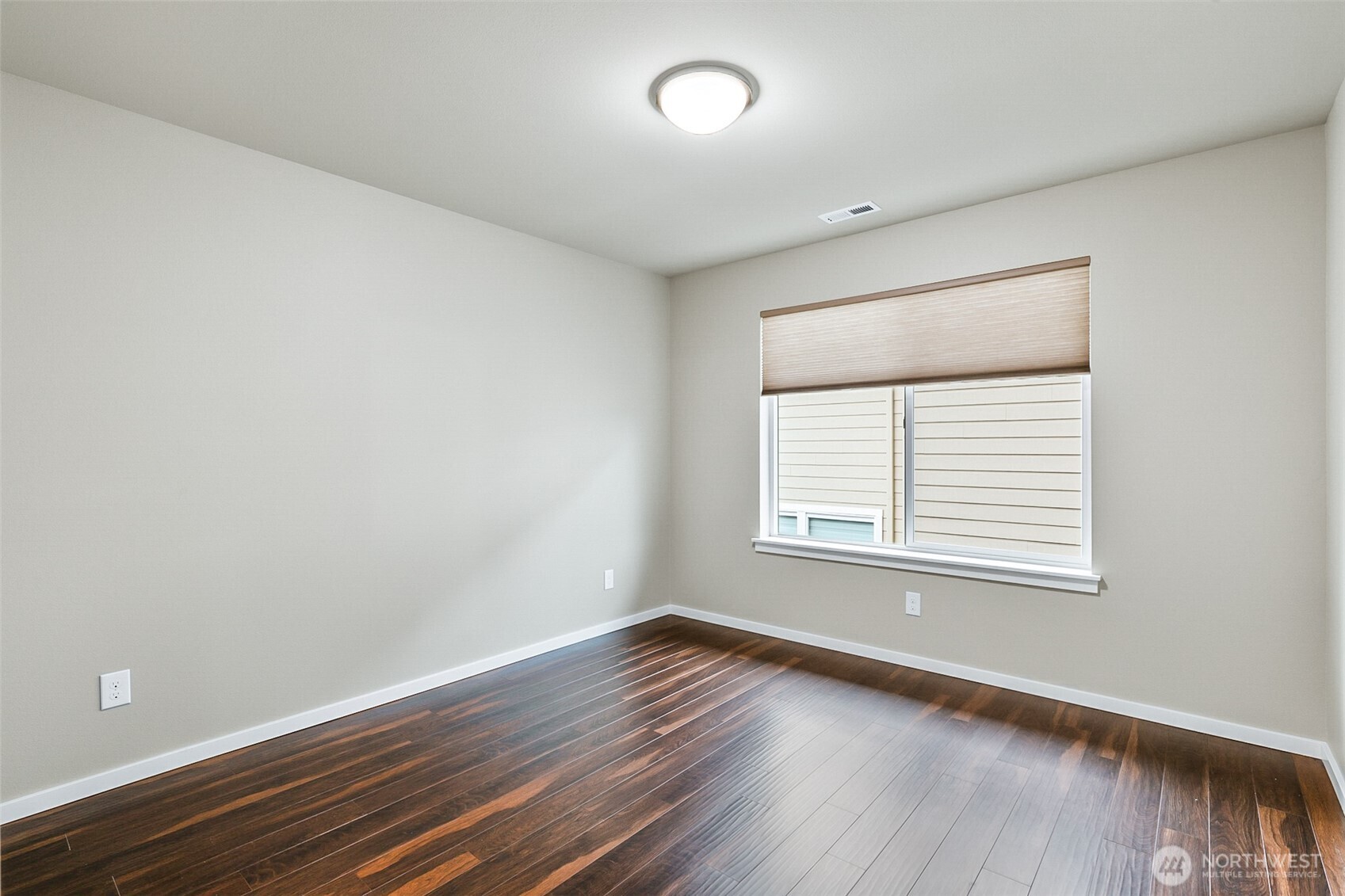 4009 168th Place Southeast Bothell, WA 98012 - Photo 30 of 38 an empty room with wooden floor and windows