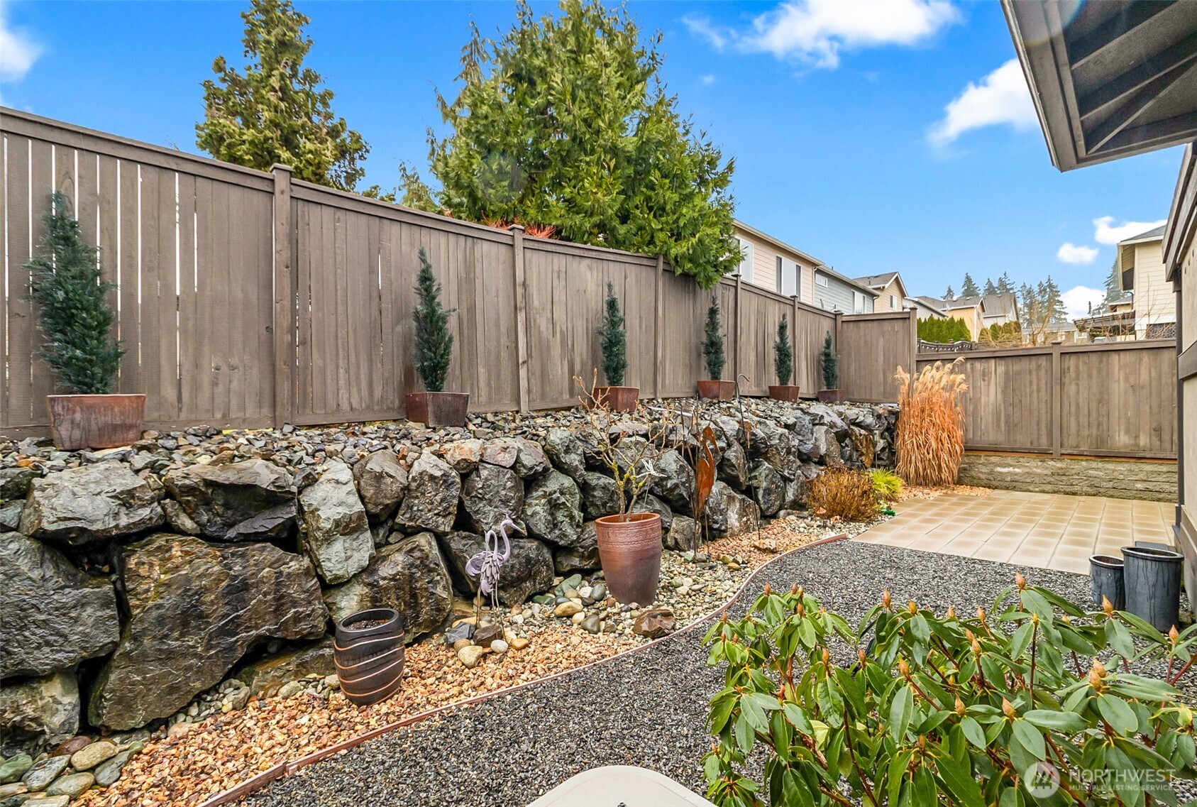 4009 168th Place Southeast Bothell, WA 98012 - Photo 36 of 38 a view of a backyard with table and chairs with wooden fence