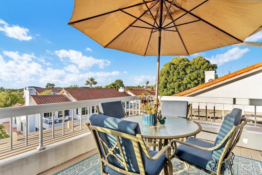 4169 Rhodes Way Oceanside, CA 92056 - Photo 5 of 42 a view of a patio with table and chairs under an umbrella