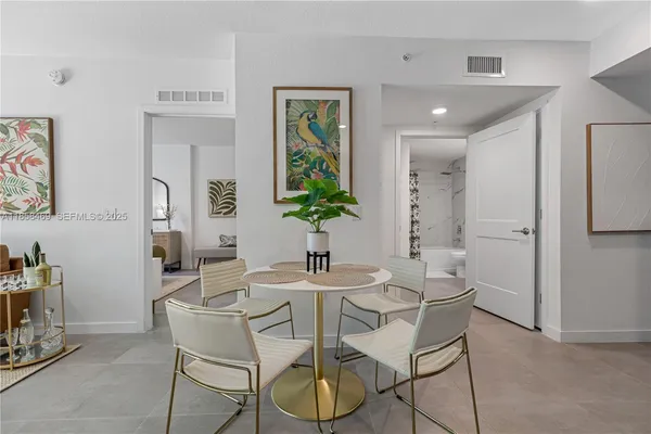 a dining room with furniture and window