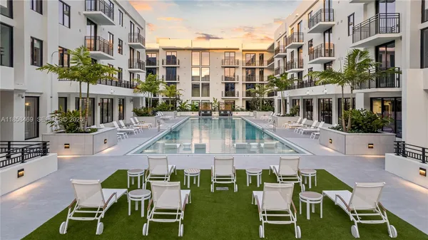 a living room with furniture flowerpot and window