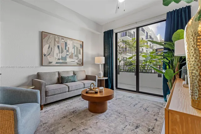 a living room with furniture and a potted plant